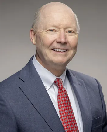 Professional portrait of a man in suit and red tie